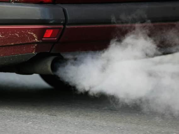 A car plumes smoke for its exhaust